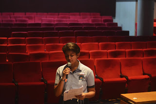 student speaking on a stage