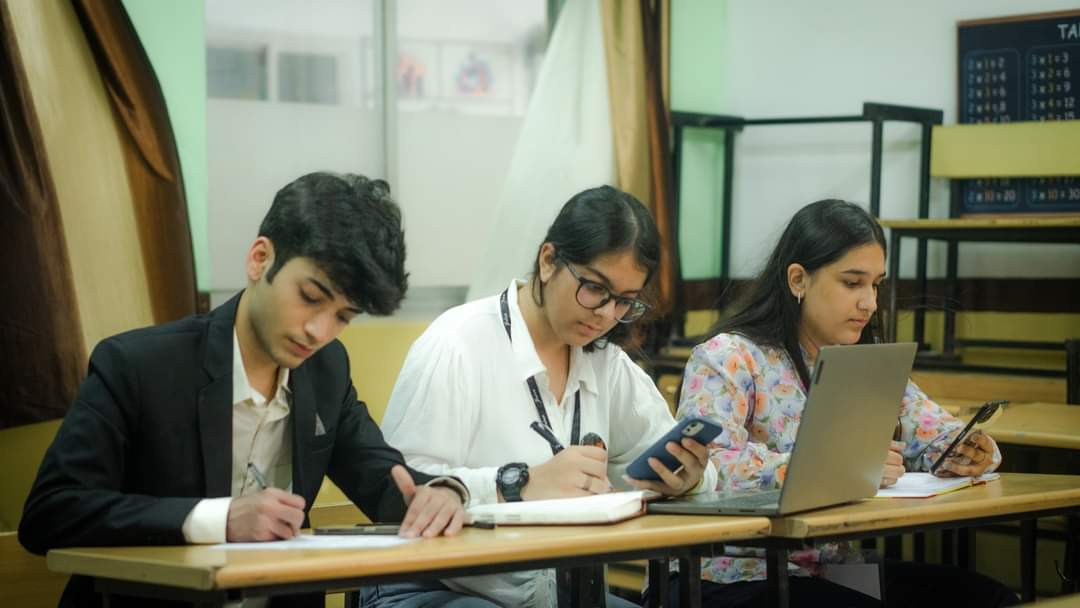 students sitting and writing